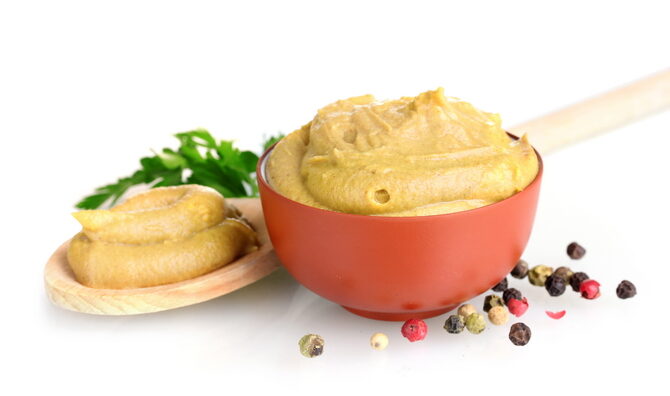 mustard-in-bowl-and-spoon-spices-and-parsley-isolated-on-white